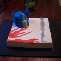 Transformer rkt transformer head covered in fondant. french vanilla cake with raspberry filling and buttercream.