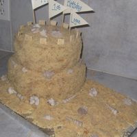 Sandcastle Cake White cake with pineapple buttercream filling. Sand is made from Pecan Sandies and Nilla Wafers. 10" and 8". shells are white...
