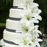Polka Dot Wedding Cake My most current wedding cake with a polka dot theme finished in white fondant with black and white polka dot ribbon, large lillies, and...