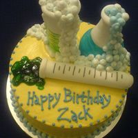 Science Theme Birthday Cake I found this idea on line. The cake is frosted and the lab containers are made out of fondant. Thanks for whoever made this cake originally...