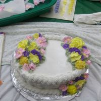 Wilton's Course 2 Cake drooped a bit, but decorate and learn. Buttercream with mostly royal flowers.