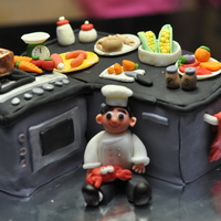 Chef's Kitchen This is made for a chef who teaches from home. The cake is carved from 1 and a half 6 inch square, filled with chocolate and cherry soaked...