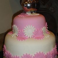 Pig And Daisies Two-tiered cake dressed in MMF with daisies using a fondant punch. Silver piggy bank was my mother's.