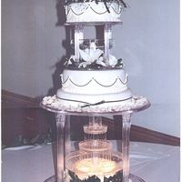 Black & Ivory This cake was in ivory fondant with black accents. The flowers are real and the "cake" is a white chocolate cheesecake.