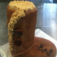 Ugg Boot All cake carved and covered in fondant. Fur is royal icing and we used chalk for the shading of the boot.