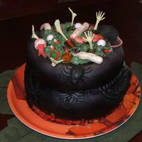 A Halloween Cauldron Cake I spent 3 days on this thing for my moms office. took it today, everyone loved it. cauldron is mmf and decorations are part candy from...