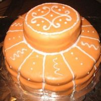 Orange_Fondant_Cake.jpg cake baked in a kind-of-flower shaped pan, covered with orange MMF and icing ( just for practicing)
