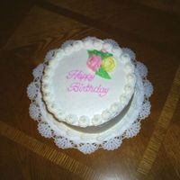 Birthday Cake 8" round, buttercream with royal icing flowers.