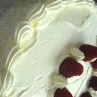 Perfect Party Cake White cake layers filled with raspberry jam and vanilla italian meringue buttercream