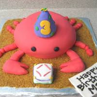 Crab Cake Crab cake for 3 yr old birthday. Chocolate and Vanilla layers with chocolate butter cream covered in MM fondant. Sand is toasted vanilla...