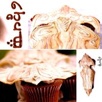 Elvin Warrior Shield Shield - gumpaste "aged" with food coloring and gold pearl dust. Cake (and cupcakes) supporting shield underneath - chocolate...