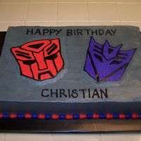 Transformers - Autobot & Decepticon Birthday For the son of a friend of mine for work. He loves the Transformers so I did a half chocolate, half vanilla sheet cake (10x15x3") with...