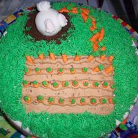 Bunny And Carrots This is a cake I did for my god mother for easter. The bunny ate too many carrots and can't get into his hole! HA!