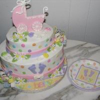 Girl Dot Baby Shower Cake Carriage on top inspired by Boween. The pattern is in one of the Wilton yearbooks. Cake made to match the partyware.