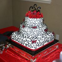 Scroll Wedding Cake All covered in fondant with RI scroll work. Feather butterflies and real carnations. My FIRST wedding cake!!! I had a blast and the bride...