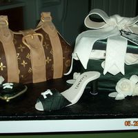 Louis Vuitton And Chanel Handpainted LV purse was WASC covered in choc. fondant, shoe box was chocolate fudge cake covered in choc. fondant. All accessories made of...