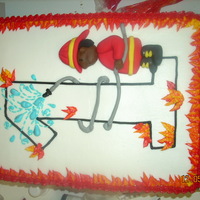 Fireman 1St Birthday This was inspired by a coloring page for a fireman themed first birthday party. Flame border, buttercream icing with fondant fireman boy.