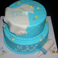 Baby Max Buttercream with fondant onsie and baby bottle. I used a diamond impression mat with viva papertowel to do the diamond pattern.