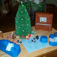 Christmas At Home.. the tree, piano, couch, chair, and ottoman are all cake. The rest is all made of gumpaste. Served 125.