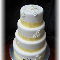 Yellow Gingham And Royal Icing Daisies 4 tiered stacked fonadant wedding cake.