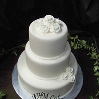 3 Tiered Round Fondant Wedding Cake with royal icing roses for ivory and chocolate color themed wedding. Very simple.