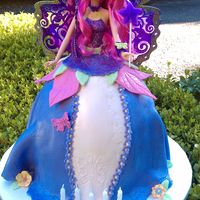 Fairy Barbie Cake Fairy Barbie is a full doll. Skirt is Yellow cake filled with Lemon Curd and fresh strawberry, covered in Fondant.