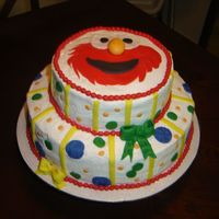 Elmo Cake This is a 2 tier..4 layer amaretto cake...iced in buttercream with fondant accents.