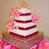 Kami's Wedding Cake This is just a simple fondant covered square cake with real ribbon and silk flowers.