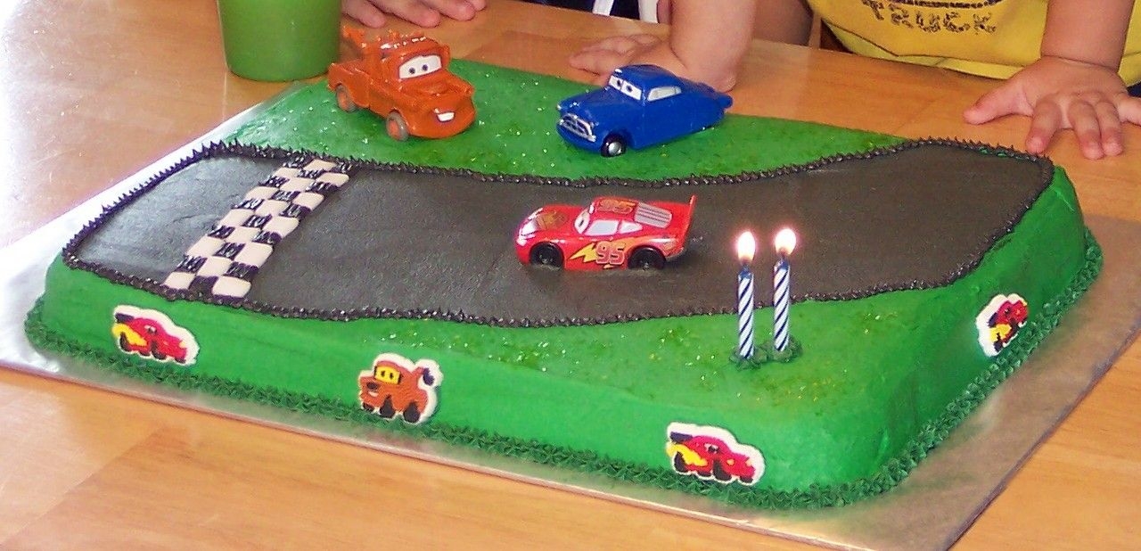 Cars Yellow cake, buttercream icing. BC and fondant finish line and toy cars. Simple but the two year old loved it!