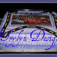 Cars 1st Birthday cake. 1/2 choc,1/2 french vanilla/cookies and cream. Buttercream with edible transfer and fondant. Design provided by customer...