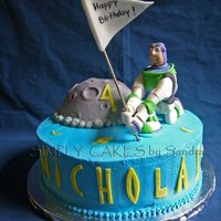 Buzz Lightyear Buzz Lightyear cake for a 4 years old kid. Half chocolate, half yellow cake with strawberry filling. Moon was chocolate cake. Buzz...
