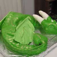 Green Dragon Cake Made this for a friend moving away! =( He loves dragons! Head, part of tail and horns made of rice krispy treats, hand-molded to what i...