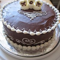 Mom's Day Cake Chocolate cake with chocolate frosting and white buttercream accents. Also made some lil white chocolate hearts to stick on top!