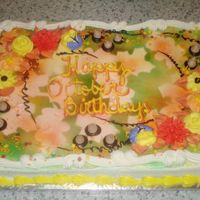 Fall Birthday Cake Half sheet cake iced in buttercream. Leaf patterns cut out of card stock and laid around on top of the cake and then used the canned color...