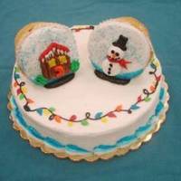 Christmas Snowglobes I made an 8 inch cake and iced two large cupcakes on their sides to make snow globes.