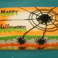 Green Ooze 1/4 Sheet Cake Airbrushed Halloween cake made with buttercream icing. Spider web and green ooze piped running down the side of the cake
