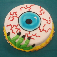Eyeball Cake 8" round single layer cake made with buttercream icing. Airbrushed the eyeball and made everything else out of buttercream.