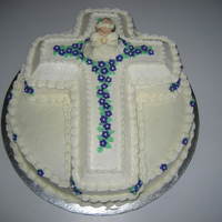 First Communion Made this for a neighbor's first communion. Inspired by a cake by tcdup! Wilton cross pan on a round cake. Iced in buttercream, royal...