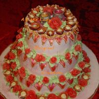 Deepawali Cake, Side View Eggless 3 tier coconut cake, iced in rose BC with BC and chocolate accents.