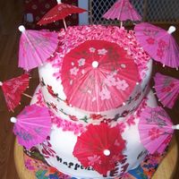 Cherry Blossoms And Umbrellas Cake covered in mmf with stenciled characters, writing and flowers painted using food coloring and extract. MMF cherry blossoms all over...