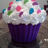 Giant Cupcake Cake Strawberry cake with whip cream icing and fondant decorations.