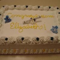 Simple Graduation Cake This was a white cake with strawberry mousse filling. Icing is buttercream, diploma and grad markers were litttle purchased props.