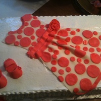 Dress On A Cake Fondant decorations...fluffy icing and strawberry cake.