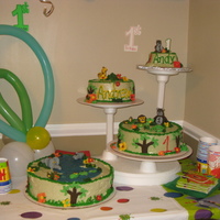 Cool Jungle Cake Jungle/Animals Theme..fluffy icing, butter cream borders and animals, tree and flowers in fondant. BTW, it was my first time making animals...