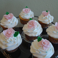 Mother's Day Cupcakes Buttercream icing done with large star tip. Roses and leaves are handmade (fondant).