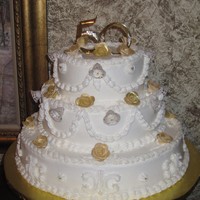 50Th Wedding Anniversary I made a replica of their original wedding cake but added the gold roses and beads to it. Buttercream icing with fondant roses