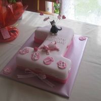 Kittykat Birthday Cake white chocolate cake iced with fondant with debbie brown style kittycats playfully adorning the cake. Topped off with wired accents