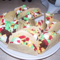 Taco Cake The shells are made with white chocolate and graham crackers crumbs. The cake is chocolate cake crumbled up butter cream and Swedish fish...