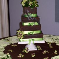 100_1900.jpg My first time covering square cakes in fondant. It's way better than trying to get good corners with buttercream, that's for sure...