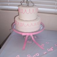 100_1765.jpg My first cake completely covered in fondant. My friend wanted the cake to mimic the invitation. that's why the uneven scallops....